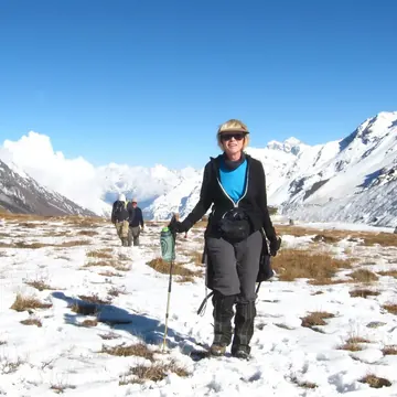 A holiday photo of a trekker on a snowy mountain trail